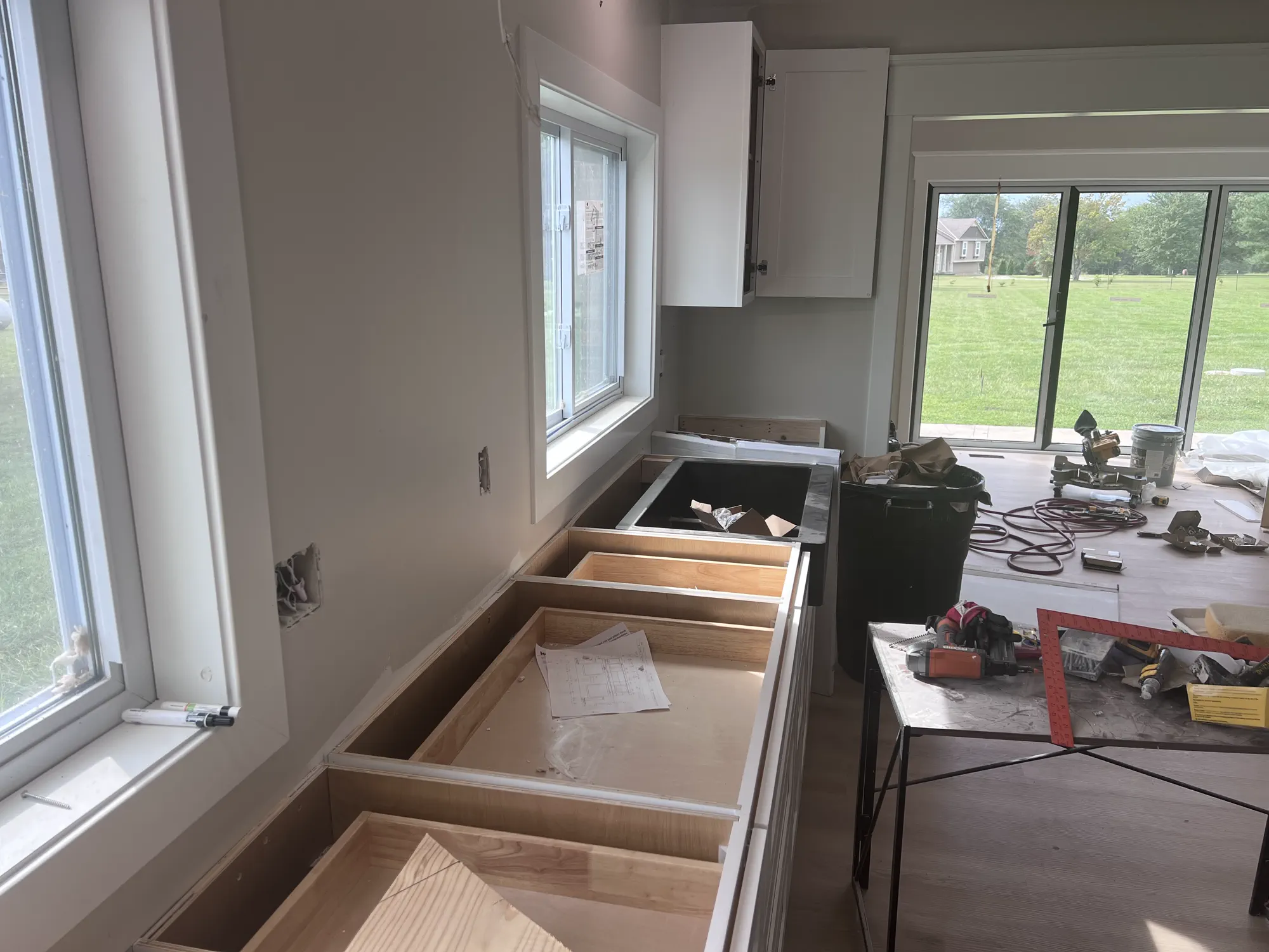 Kitchen cabinets and unfinished surfaces shown during the renovation